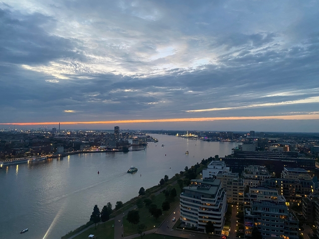 Scenic aerial view of a river flowing through a city at dusk.