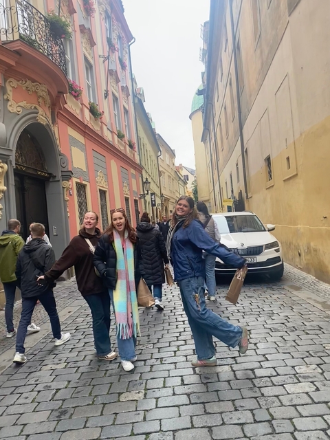 Group of friends posing on a street in Prague.