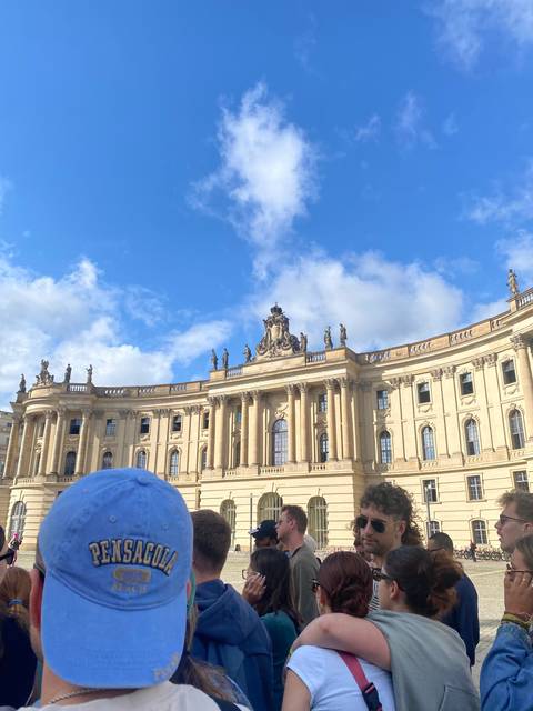 Baroque-style building with statues on the roof.