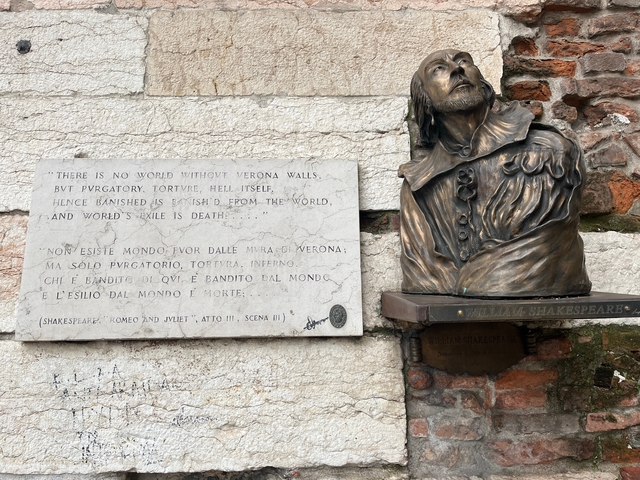       Bust of William Shakespeare with an engraved plaque attached to a wall.
  