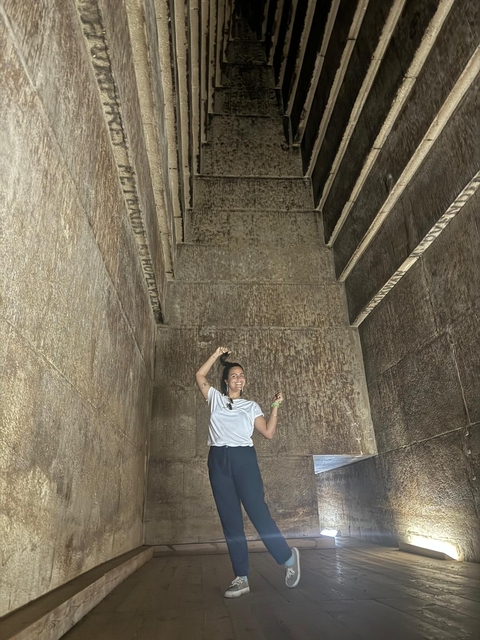       Person inside an ancient stone structure.
  