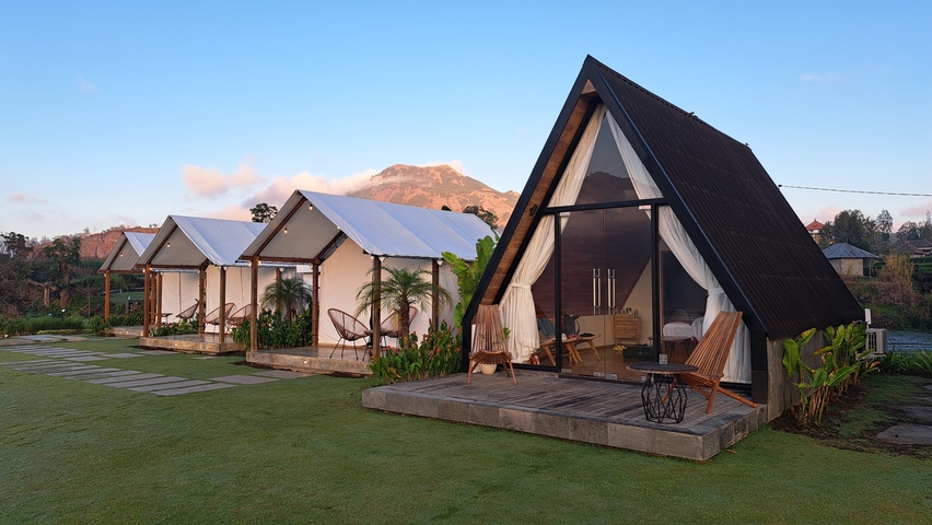 A-frame bungalows with mountains in the background.