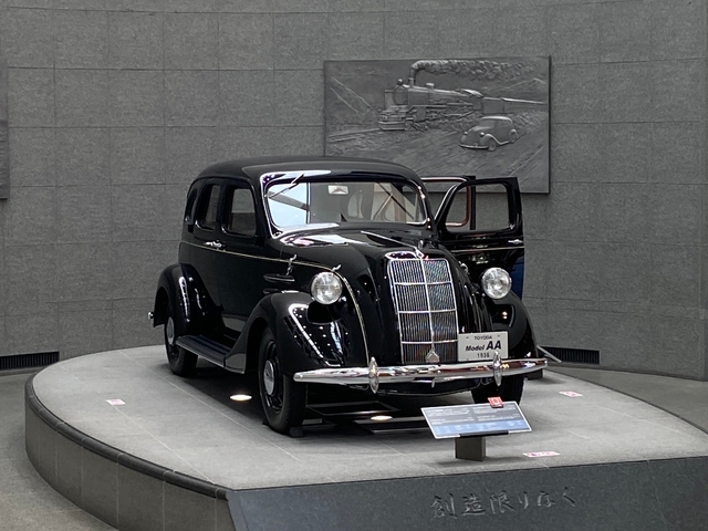 Vintage car on display at an indoor exhibit.