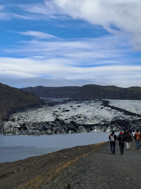       A glacier field with mountains in the background.
  