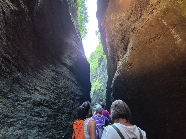 Narrow canyon with people inside.