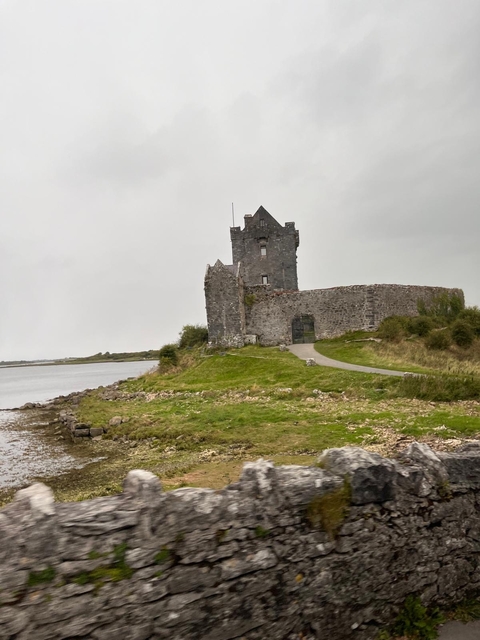 Medieval stone castle by a river.