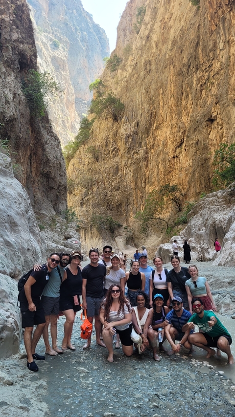 Group of tourists posing in a narrow canyon.