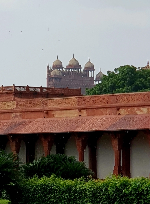       Partial view of an ancient fort with a temple tower visible.
  