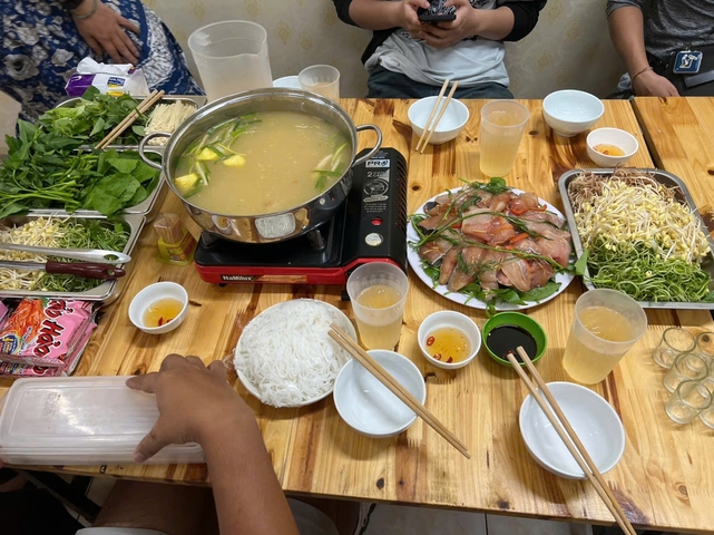 Traditional Vietnamese hotpot meal setup.