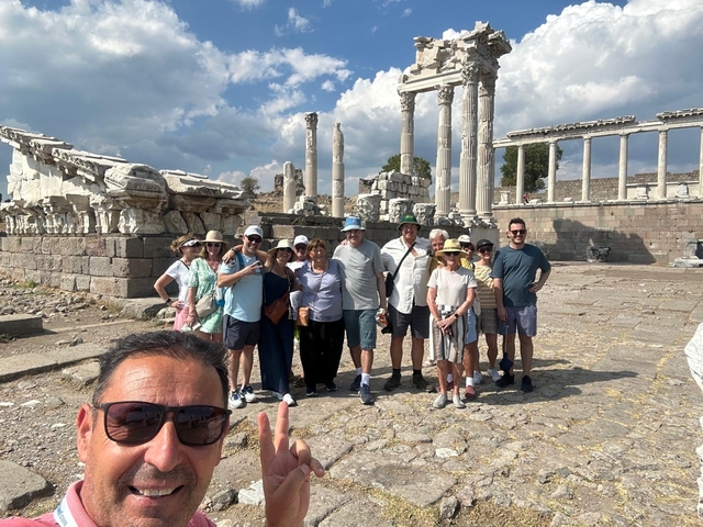       Tourists in front of ancient ruins, likely in Pergamum.
  