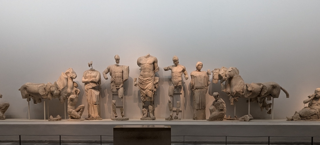 Ancient Greek sculptures on display in a museum.