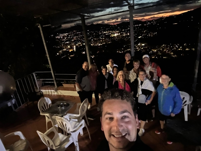 Group photo at night with city lights in the background.
