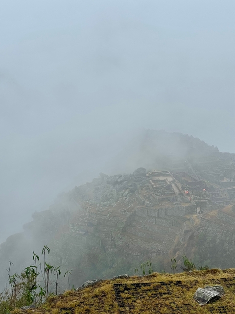 Ruins of stone structures partially covered in fog.