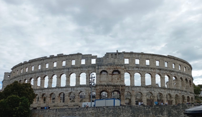       The Pula Arena with cloudy skies.
  