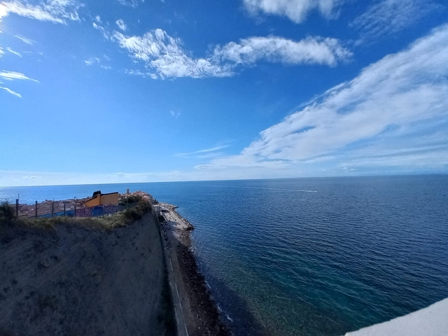       A view of the ocean under a blue sky.
  