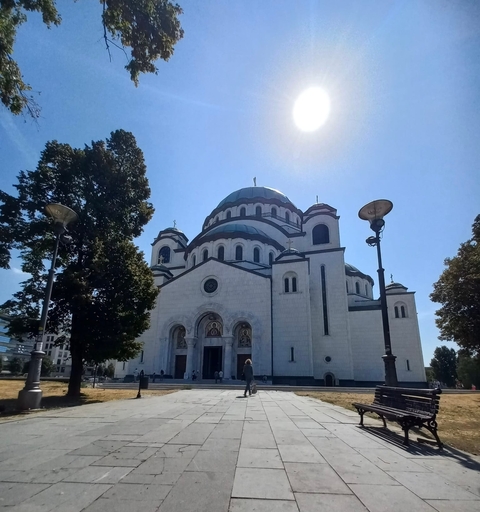       A large religious building with a dome and cross.
  