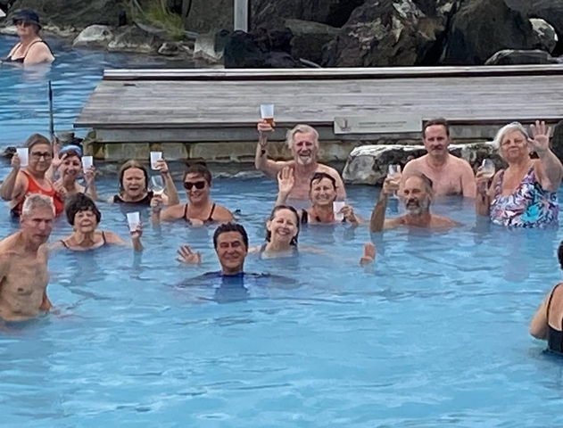       Group of people enjoying a drink in a pool.
  