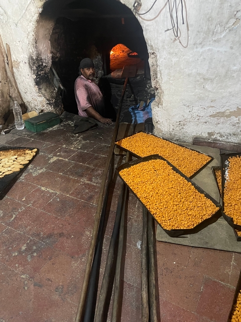 Baking area with trays of prepared food.