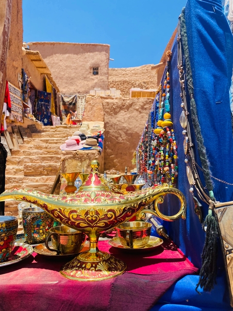       Colorful market stall with various handmade items and a hookah.
  