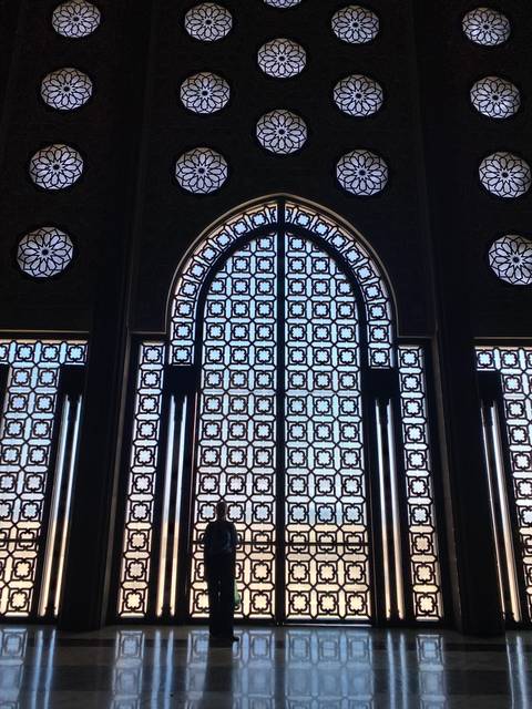       Ornate stained glass windows with geometric patterns.
  