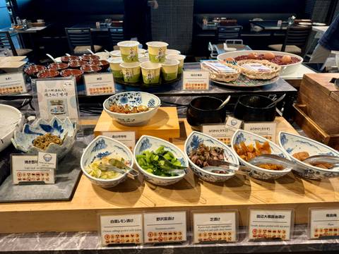 Buffet display with various dishes and labels.