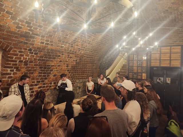 Group tour visiting an underground cellar.