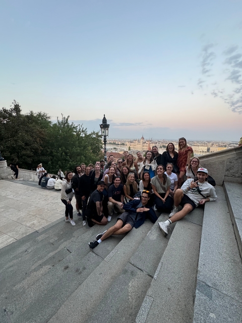 Group of people with a scenic city view at sunset.