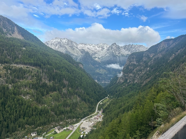 Scenic view of mountainous landscape with cloud-dotted sky.
