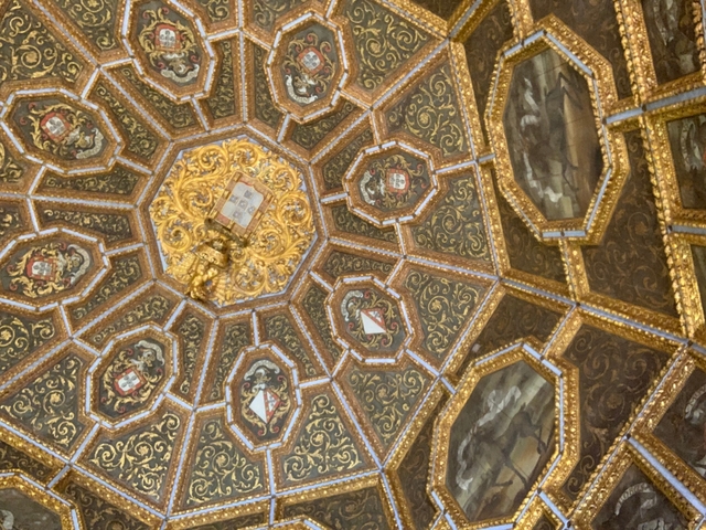 Ornate decorated ceiling with gold patterns.