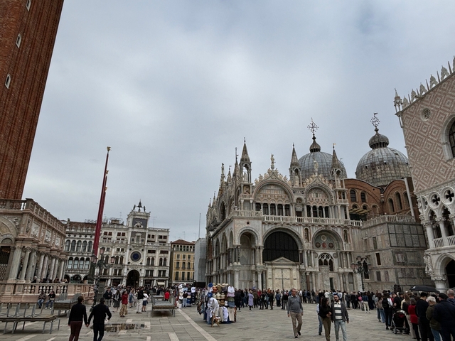       St Mark's Basilica in Venice with a crowd.
  