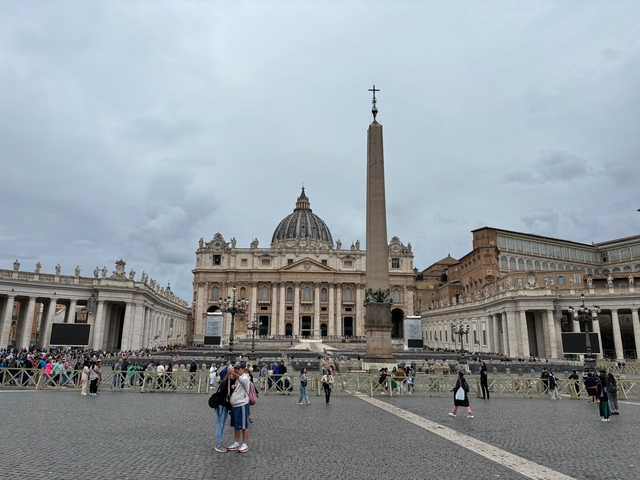       St. Peter's Basilica in Rome with a crowd of people.
  