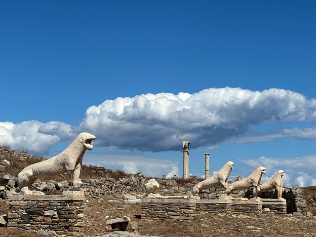 Ancient stone lions on Delos island with a blue sky.