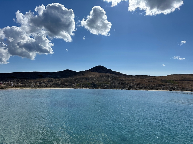 Coastal landscape with clear sky and calm waters.