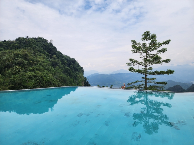 Infinity pool with mountains in the background.