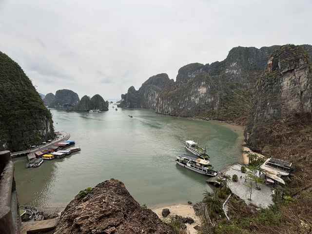 Scenic view of Halong Bay with boats and limestone islands.