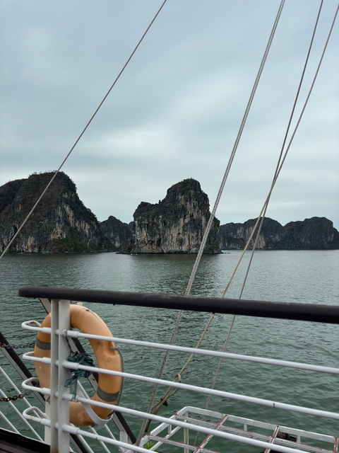 View from a boat with limestone islands in the background.