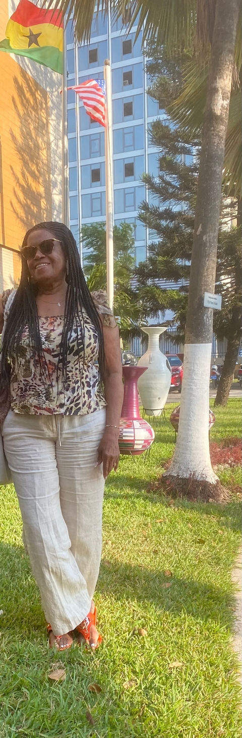       Part of a person with large pots in the background.
  