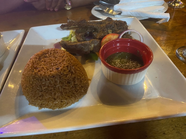       Plate with rice, salad, sauce, and meat.
  