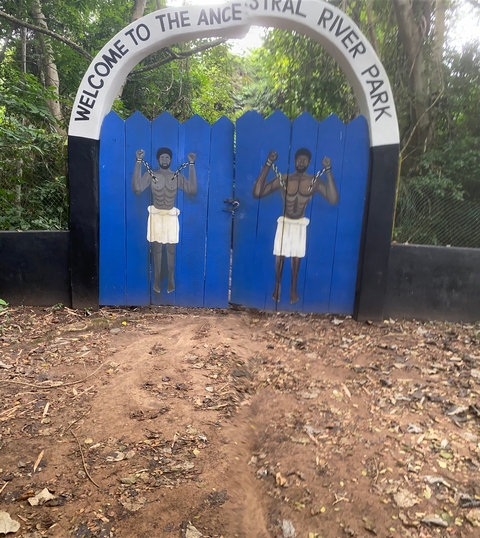       Wooden gate with painted figures.
  