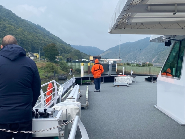 People on a boat with scenic landscape in the background.