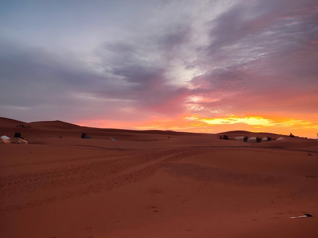       Sunset over sand dunes.
  