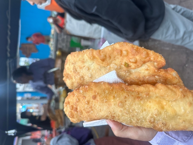 Fried pastries being sold at a street stall.