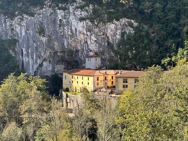       Stone monastery built into a rock face.
  