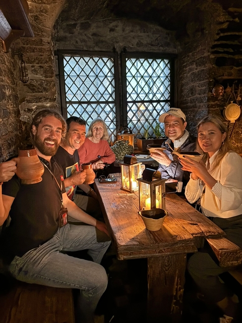 Group dining in a cozy candlelit setting.