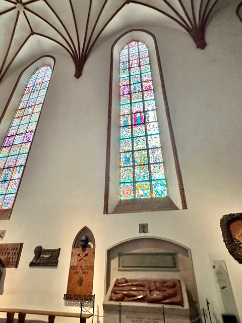 Interior of a cathedral with stained glass windows.