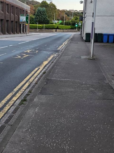       Sidewalk and road markings indicating a bus lane.
  
