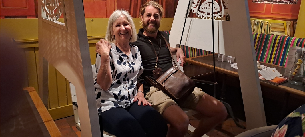 Older woman and man sitting in a casual restaurant setting.