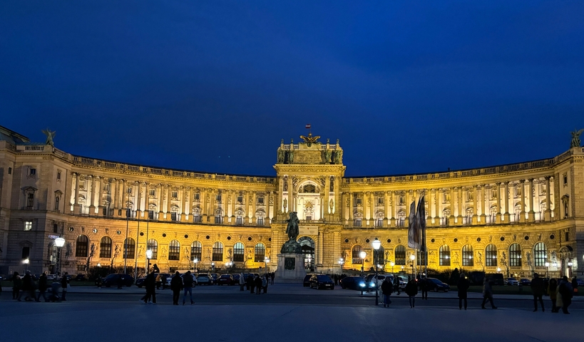 Illuminated Hofburg Palace in Vienna at night.