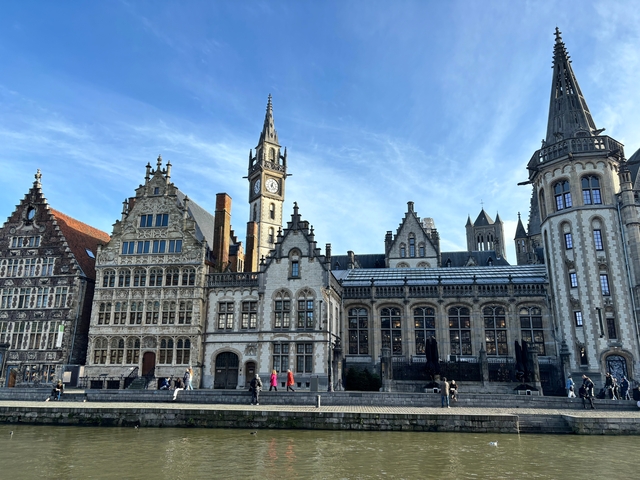 Ghent's medieval buildings under a sunny sky.