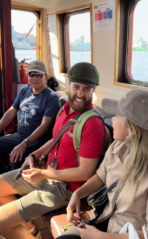 People laughing and conversing on a bus.